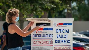 woman using ballot box