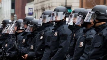 Police in riot gear lined up 