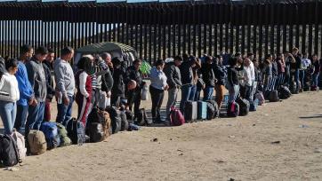 Migrants attempting to cross in to the U.S. from Mexico are detained by U.S. Customs and Border Protection at the border
