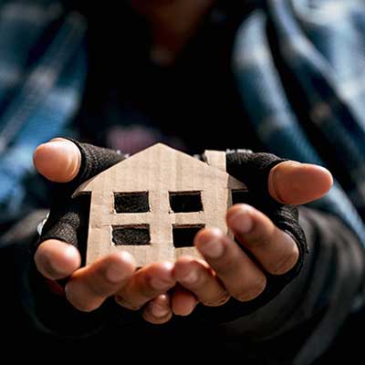 Person holding cardboard cutout of house